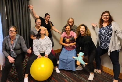 Group of women posing playfully indoors.